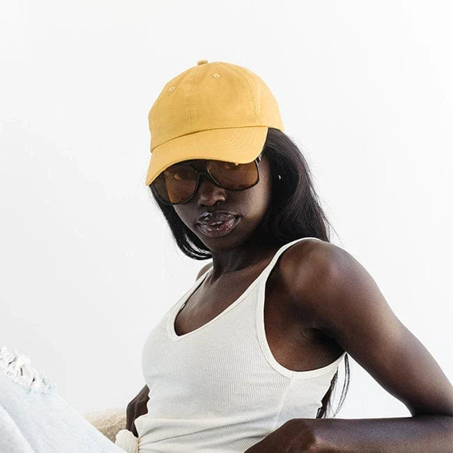 Clean girl aesthetic active clothing capsule accessorized by bright gold LBORA hat