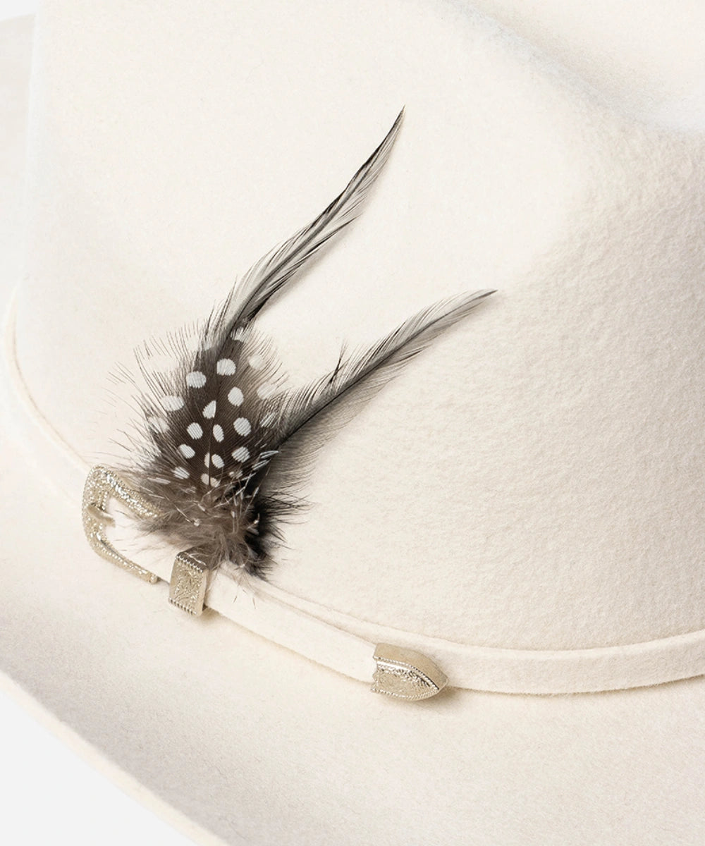 Close up on the natural feather trimming of the Frontier white luxury felt hat designed for modern ranch dressing