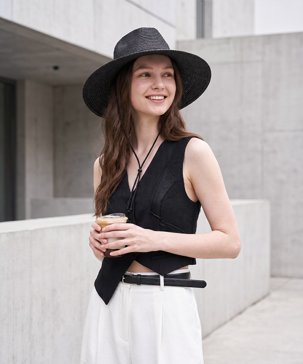 Sophisticated sun safety outfit inspiration showcasing a midnight black oversized straw beach hat