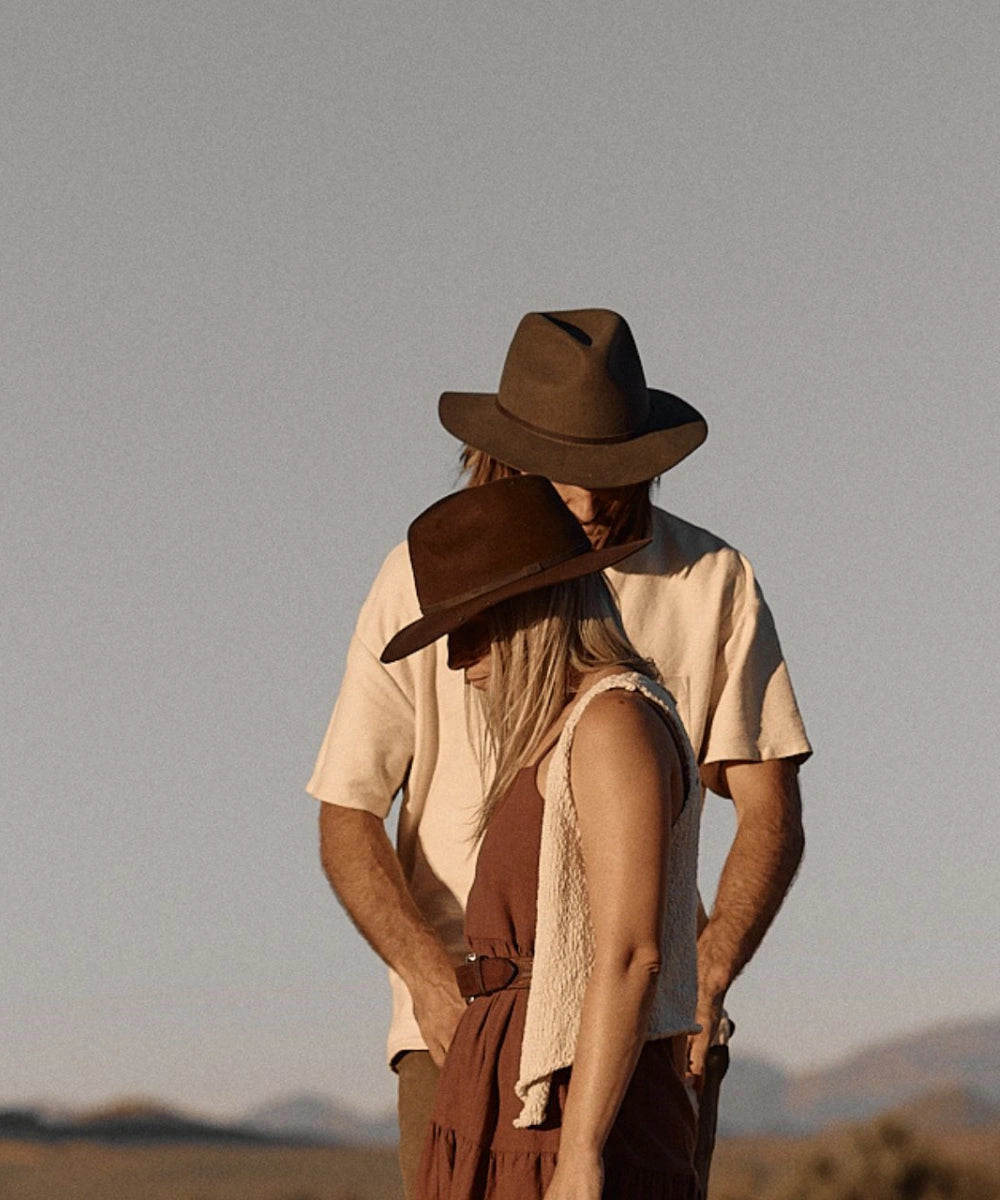 Female model showcasing the classic travel profile of the Indy brown felt fedora against a desert backdrop LBORA