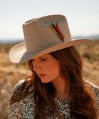 Female model wearing Latitude felt cowboy hat in natural cream color for a sharp western look LBORA