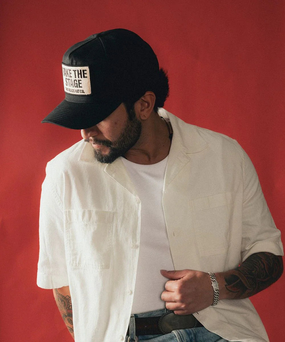 Rock aesthetic clothing capsule wardrobe piece showing a solid midnight black LBORA Headliner hat