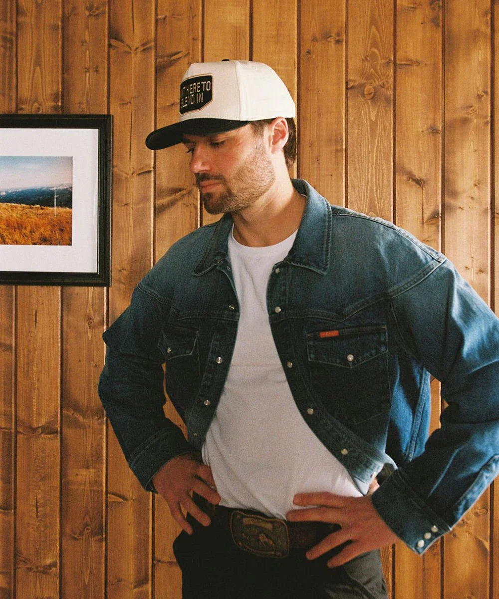 Streetwear active utility outerwear aesthetic featuring a clean bone white Outlier panel cap