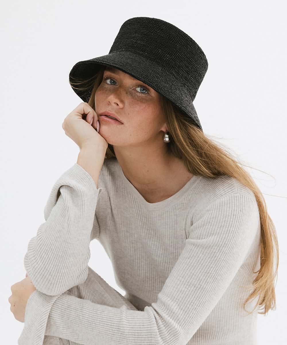 Studio presentation of the Solstice packable sun hat collection in classic black and natural straw variants